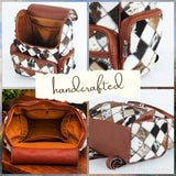 Hair-on cowhide diamond patchwork backpack – open interior and side pocket details