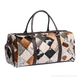 Diamond patchwork hair-on cowhide duffle bag – front view with end zip pocket