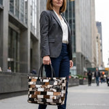 Multi-color hair-on cowhide patchwork tote bag – carried by hand on a city street