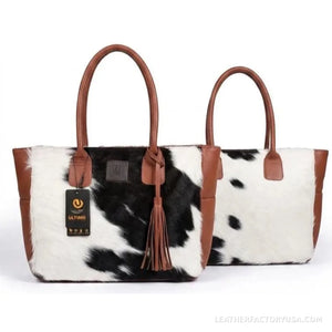 Black and white hair-on cowhide tote bag with tassel – dimensions 17 x 14 x 6 inches