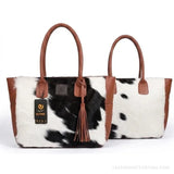 Black and white hair-on cowhide tote bag with tassel – back view