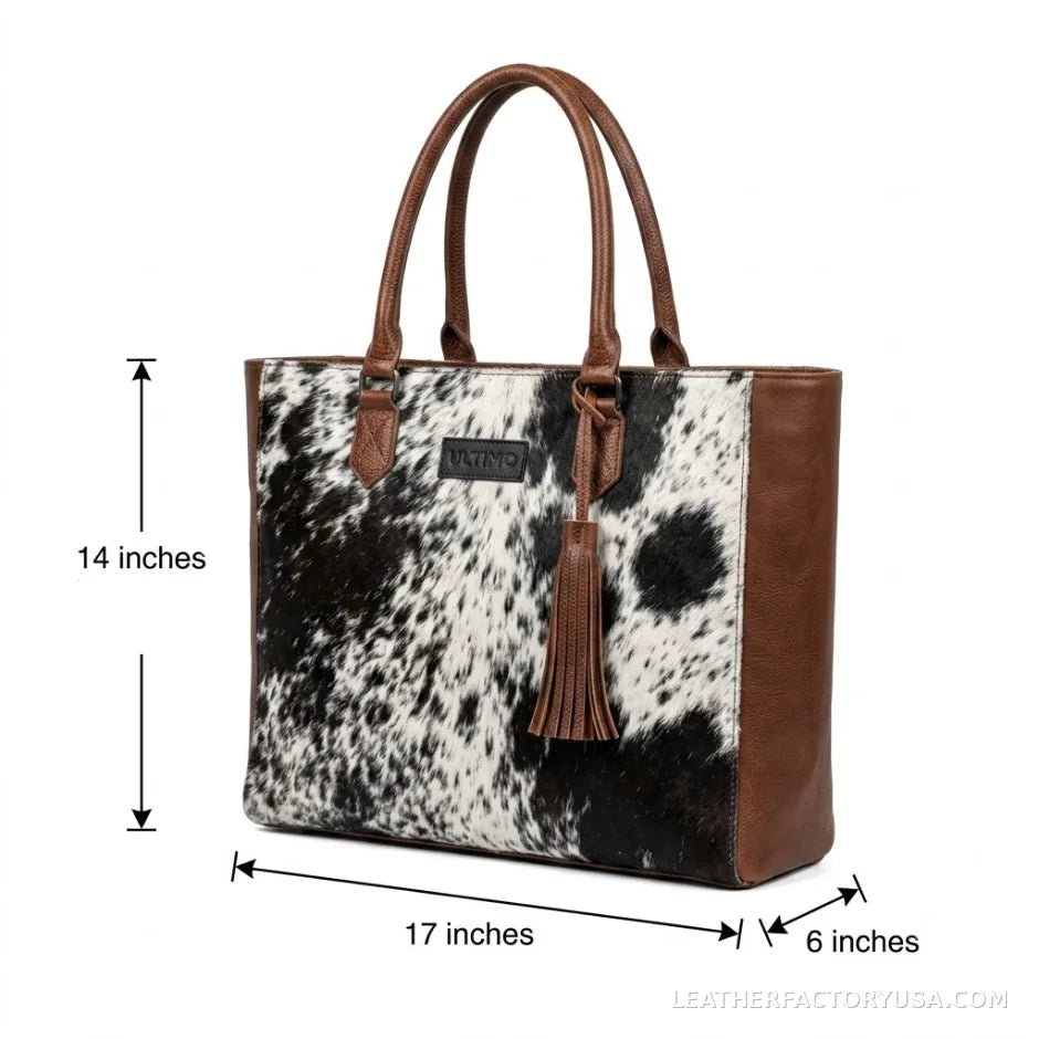 Black and white hair-on cowhide tote bag with tassel – dimensions 17 x 14 x 6 inches