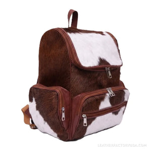Brown and white hair-on cowhide backpack – front view with zip pockets